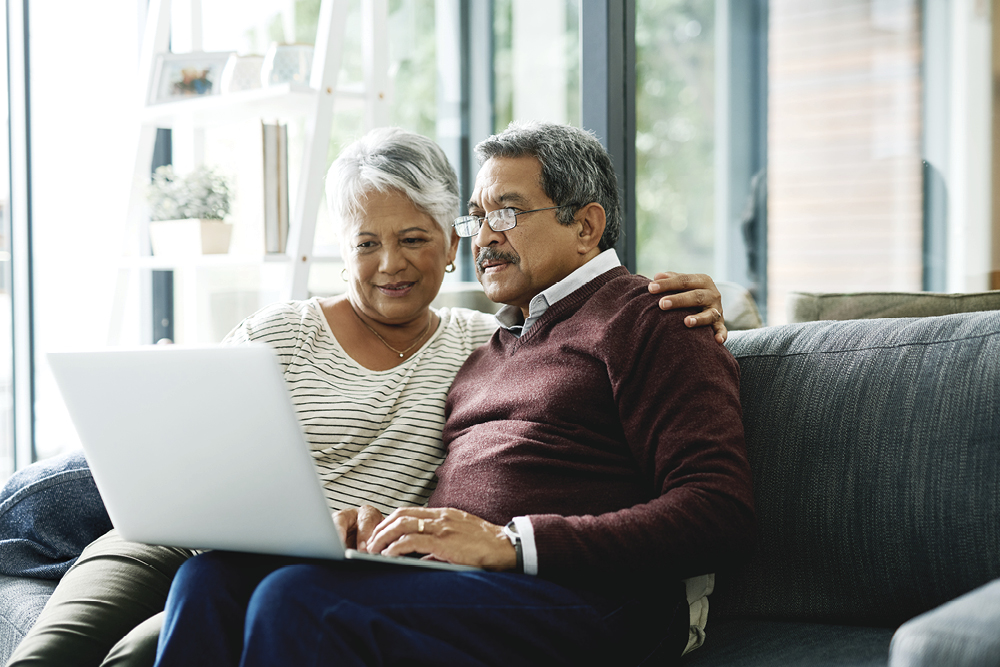 a couple talking together in front of a computer