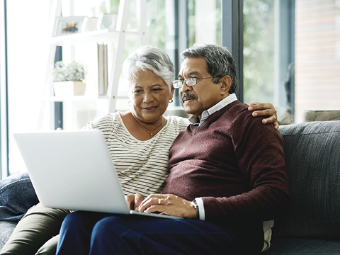 a couple talking together in front of a computer