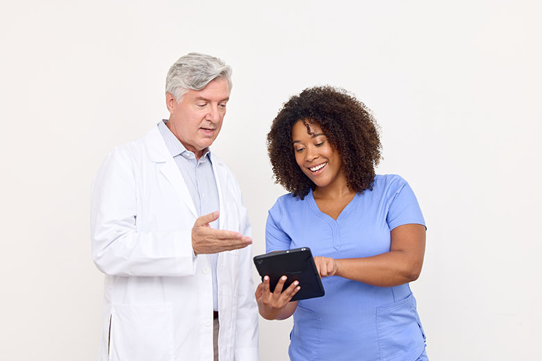 clinicians looking at tablet together