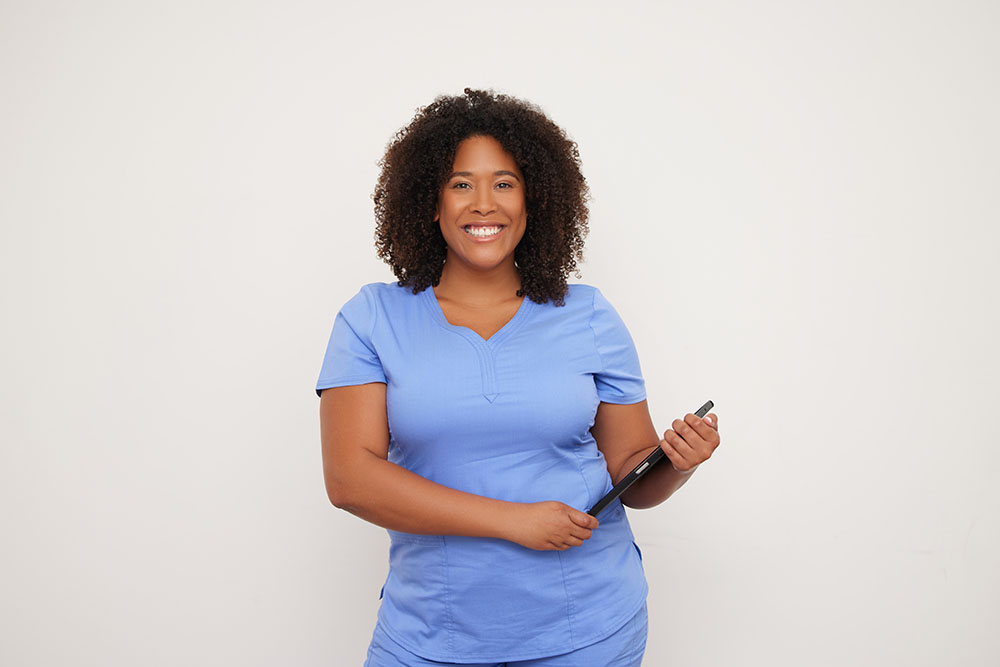 Clinical employee standing with tablet